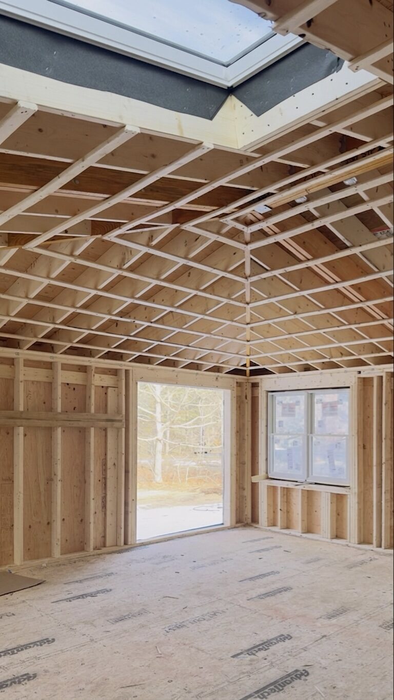 Vaulted room addition during framing with a new skylight installed