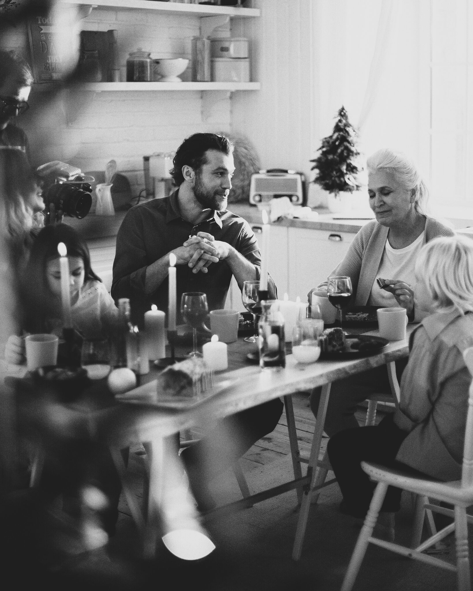 Family sharing a meal together around a farmhouse kitchen table